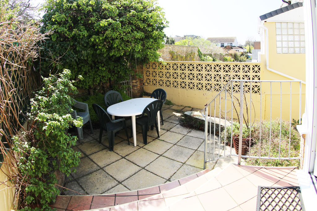 Private courtyard garden to the rear with garden furniture at Harbour View self-catering accommodation in Brixham, Devon.
